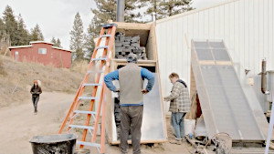 People installing glass onto the food dehydrator.