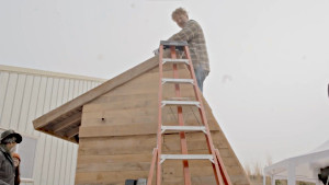 Man working on the top of food dehydrator.